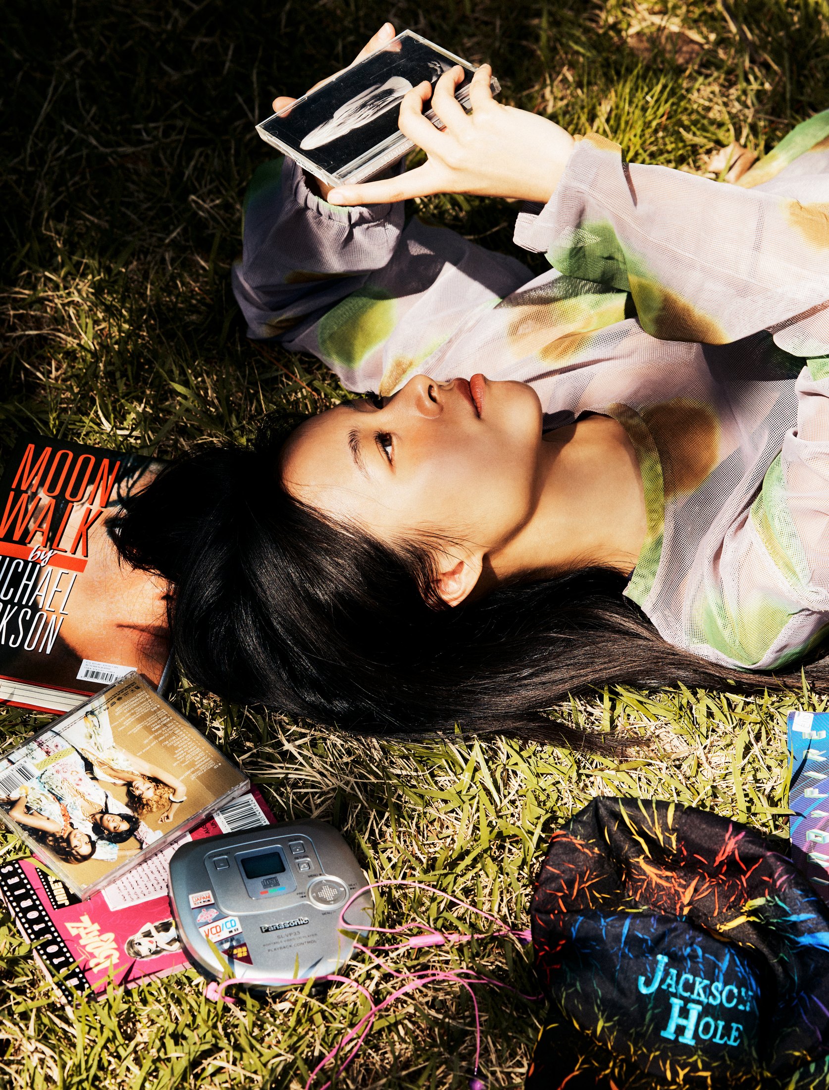 SUZIE VROWN lying in grass with music objects