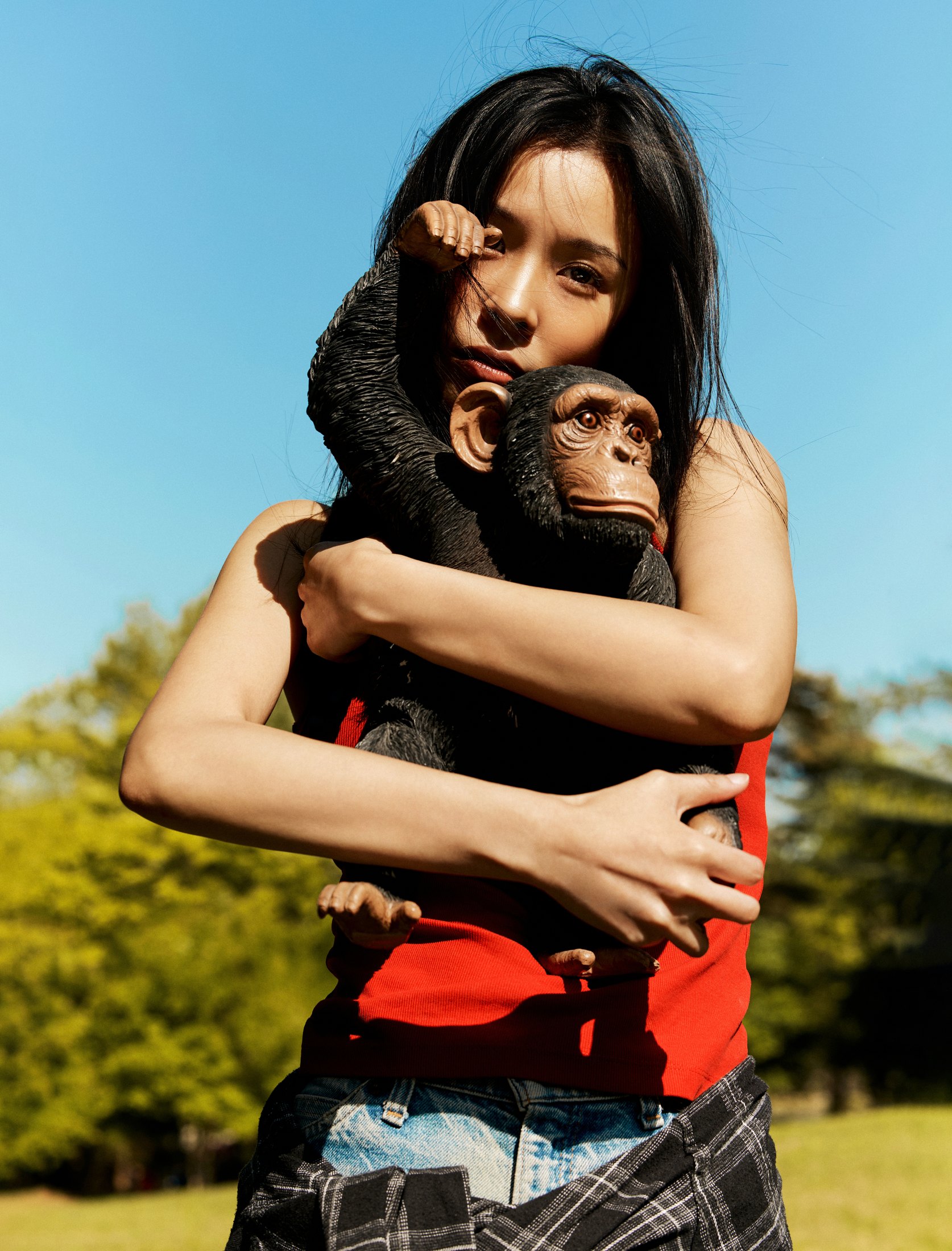 SUZIE VROWN red top portrait with a toy figure