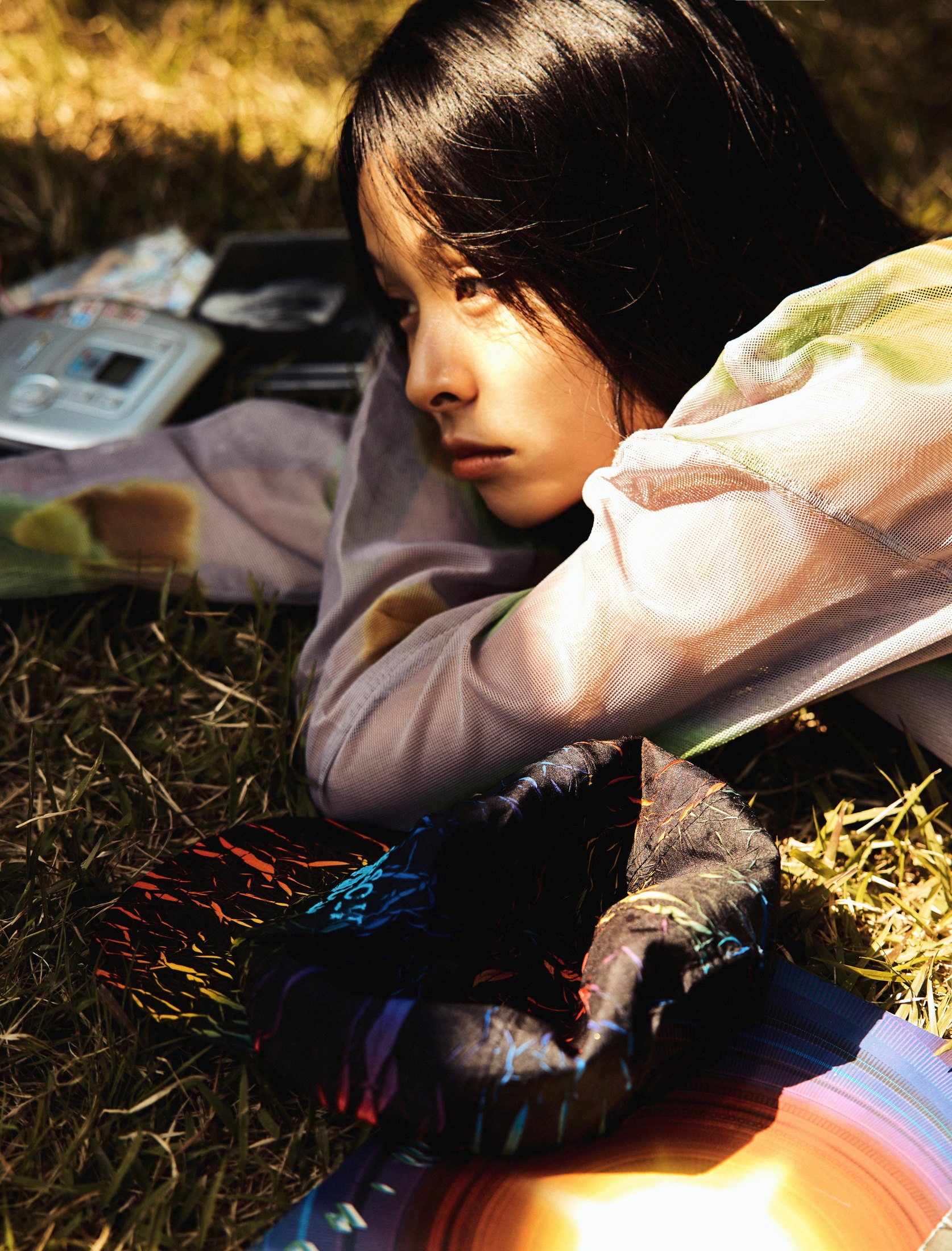 SUZIE VROWN lying in grass in side profile