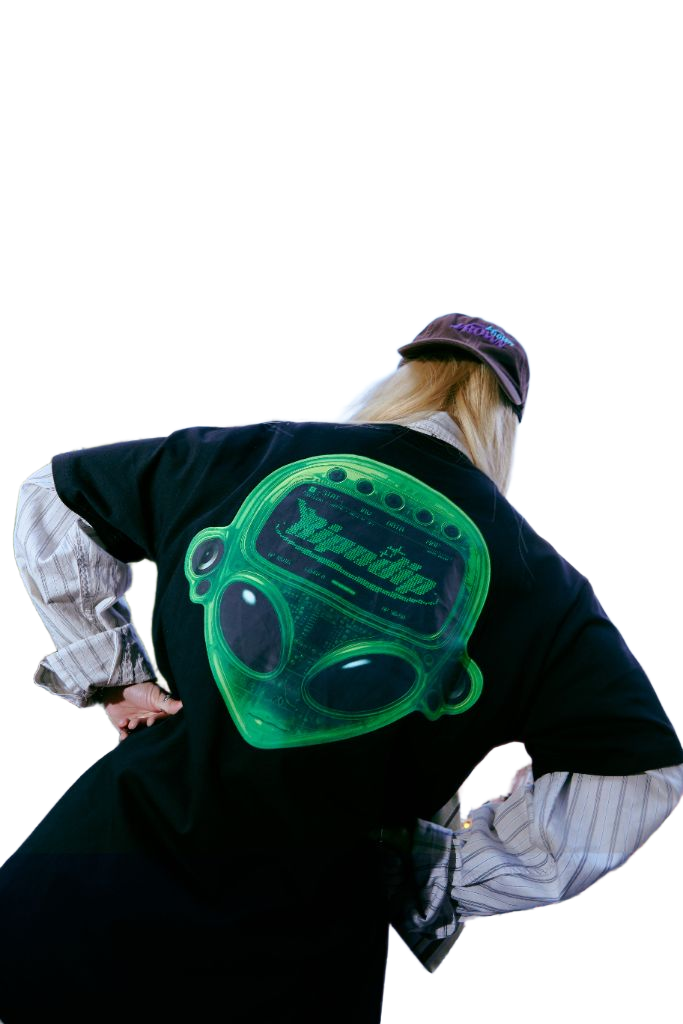 Back view of SUZIE VROWN wearing a green graphic shirt
