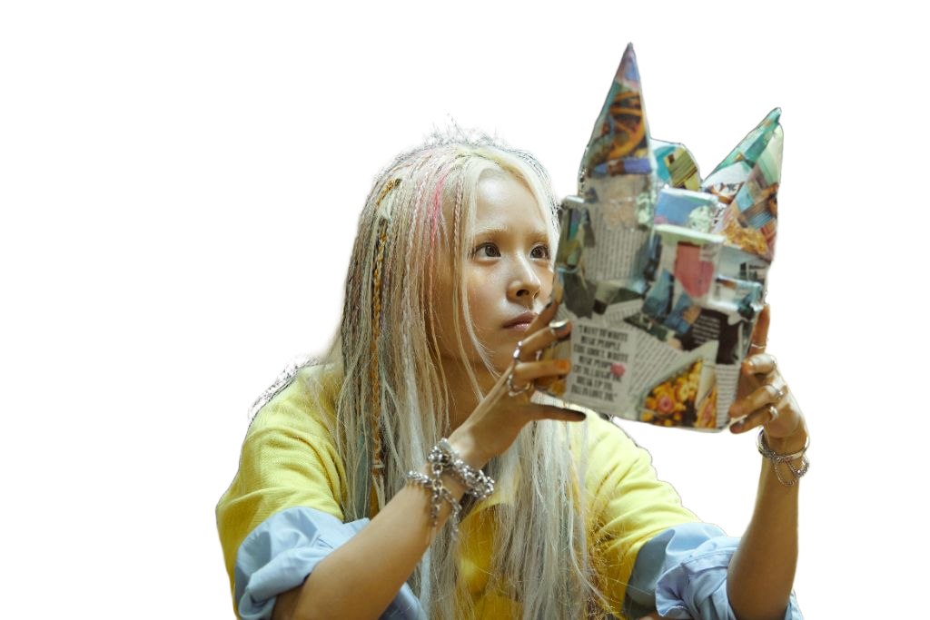 SUZIE VROWN holding a handmade collage mask